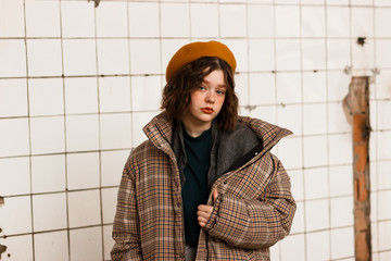 Half length portrait of young female in beige hat