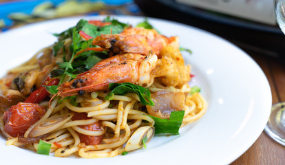 close up side viwe spicy spaghetti stirfried seafood thai food, tum yum talay