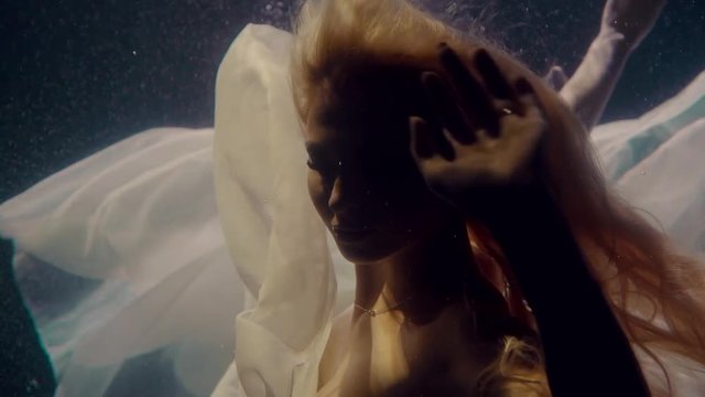 Woman's portrait underwater.