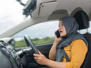 Female Driver Making a Call While Driving a Car