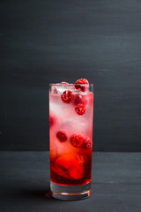 Sweet raspberry Tom collins cocktail. Selective focus. Shallow depth of field.