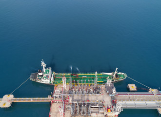 Aerial view Oil ship tanker at refinery bridge loading oil for transportation on the sea. - 249535570