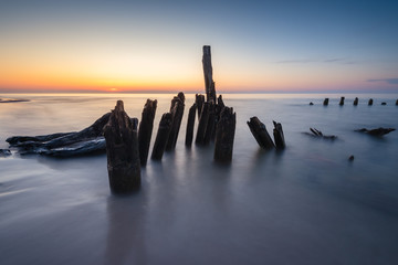 Stakes on the Baltic sea at sunset time, Karwia village, Poland