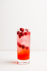 Sweet raspberry Tom collins cocktail. Selective focus. Shallow depth of field.
