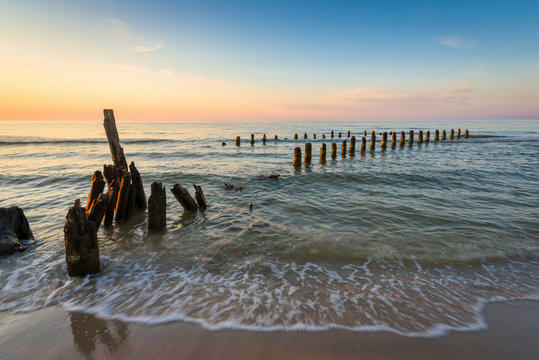 Stakes on the Baltic sea at sunset time, Karwia village, Poland