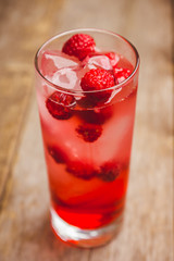 Sweet raspberry Tom collins cocktail. Selective focus. Shallow depth of field.