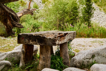 old table made of solid wood with stones, picnic area