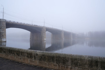 View of the New Volga bridge in a thick morning fog. Russia, Tver