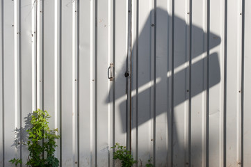 The metal fence with shadow. Abstract background