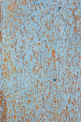 Rusty iron sheet covered by old blue paint. Abstract background