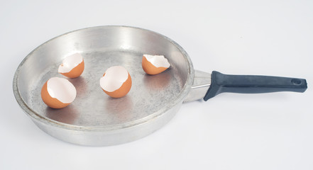 Eggshell with hot pan on background.
