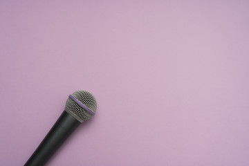 Vocal microphone in the left-down corner of purple background