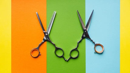 Scissor and thinning scissor of hairdresser on the background of pastel paper in the form of...