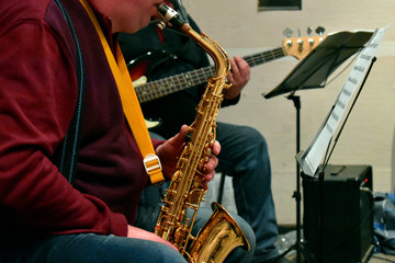 Naklejka premium musicians playing the saxophone and guitar fragment