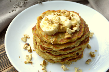 Stack of oatmeal pancake with banana, nuts and honey Healthy Breakfast