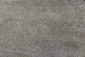 Dark gray stone with a rough and matte surface. Grunge background with space for text or image. Empty template and mockup for designers.	