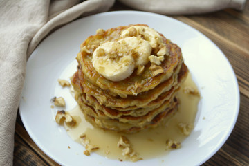 Stack of oatmeal pancake with banana, nuts and honey Healthy Breakfast	