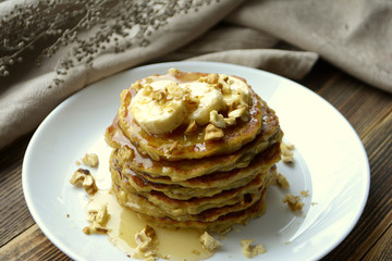 Stack of oatmeal pancake with banana, nuts and honey Healthy Breakfast