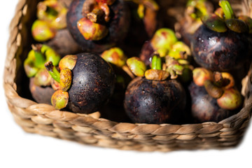Fresh ripe mangosteens in basket. Asian fruit - purple mangosteen or garcinia mangostana. Closeup. Thai exotic fruits.