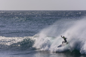 Rear View Of Man Surfing In Sea