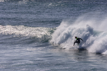 Rear View Of Man Surfing In Sea