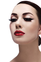 Portrait of young beautiful woman with red lips and cat eye make-up