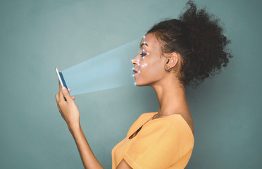 Woman with smartphone using face ID recognition system