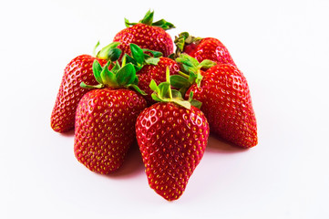 Handful of a big red strawberry on a white background