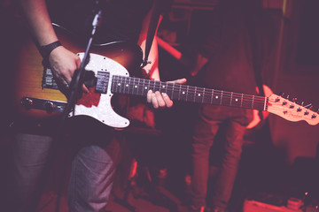 Obraz premium A guitarist makes a solo during a concert