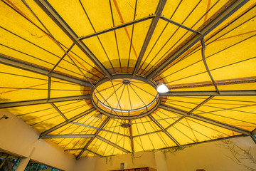 Tilt angle, Under a large outdoor yellow roof top tent with steel frame or structure