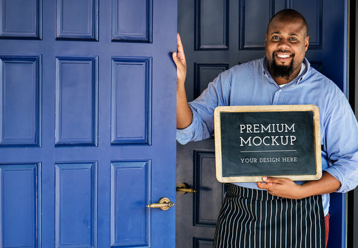 Shop Owner with Chalkboard Sign Mockup