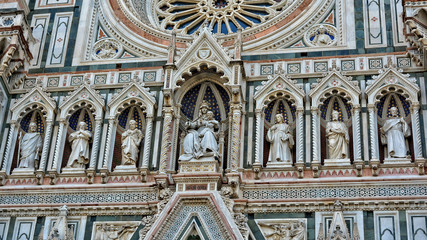 Italian Renaissance. Duomo Florence Cathedral is the third largest church in the world. Architectural details of awesome marble facade with sculptures, painting, rosette. Italy, Florence