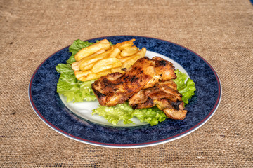 Tasty Fresh Roasted Chicken, served on a plate with lettuce and potatoes