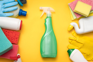 Window cleaning. Atomizer on yellow background. Supplies assortment border. Flat lay.
