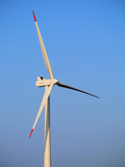 Wind farm generator tower and rotor blades assembly.