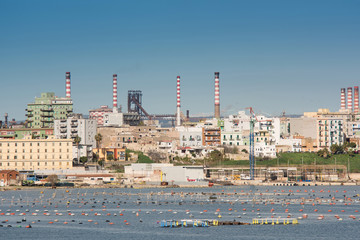 Naklejka premium Panorama of Steel plant industry on the sea side very close to the old city of Taranto, Puglia. Italy