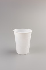 Round white Plastic Cup isolated on grey background