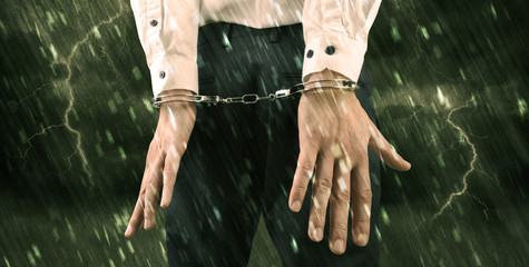 Stormy bad day concept with close handcuffed elegant man
