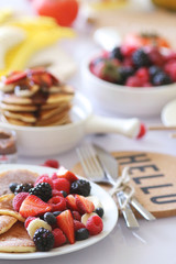 Pancakes served with many fresh fruits and berries