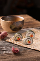 Three delicious vegan sushi rolls, vertical