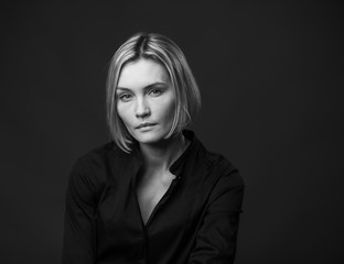 Dramatic black and white portrait of a beautiful woman on a dark background