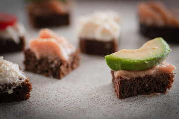 small sandwiches with different fillings. Located on a light table