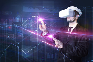 Businessman with virtual reality goggles organizing 3D graphs charts and financial variables
