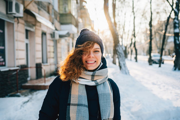 Cute happy young woman wearing warm scarf