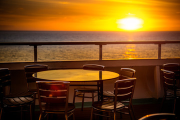 Cafe tables on balcony overlooking at sunset