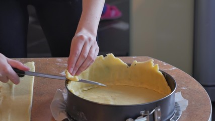 Baker forms pie crust ridges by hand