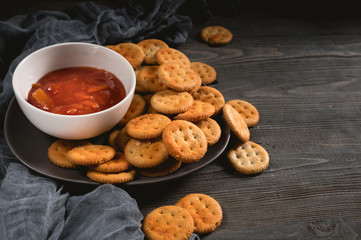 Dry thin crackers with tomato sauce