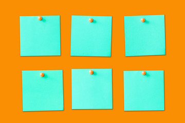 Six empty copy space blue green memo reminder cards with pins isolated on orannge background. To do list business organiser board.