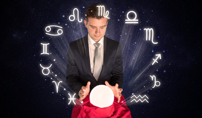 Young handsome astronaut looking for inspiration in his crystal magic ball
