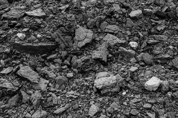 Abstract black background of limestone stones and crumbs. Land textured wall for publication, poster, calendar, post, screensaver, wallpaper, postcard